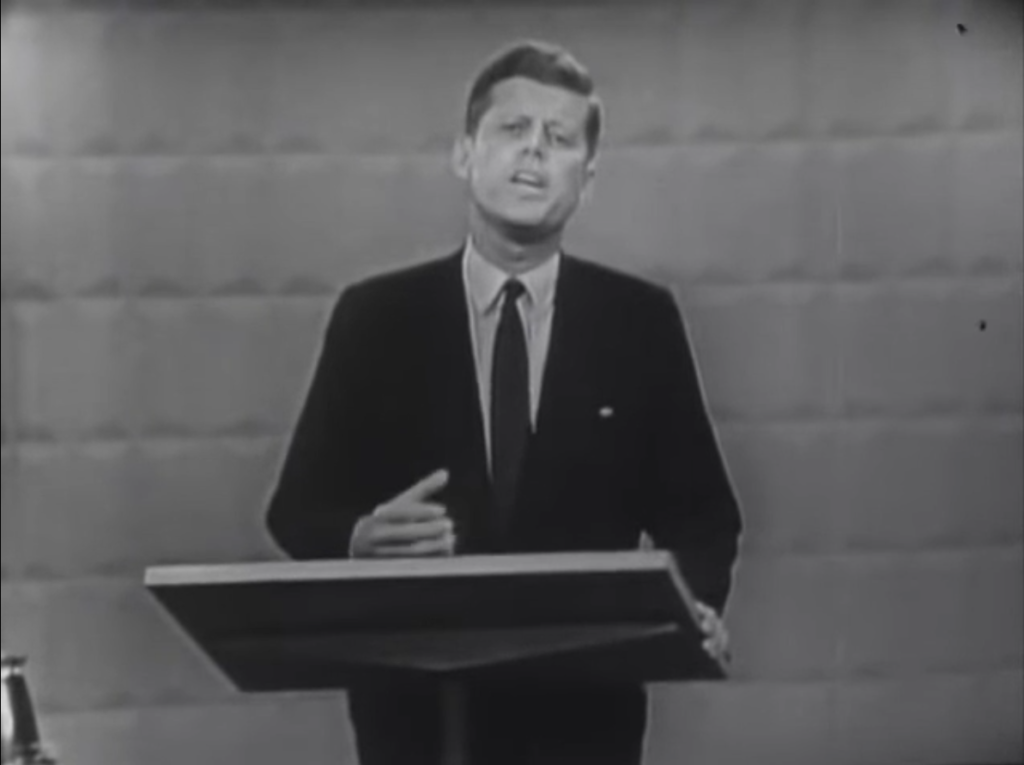 Image of John F. Kennedy standing at the podium